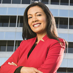 management executive smiling in front of corporate office
